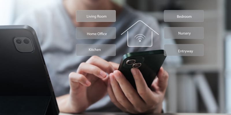 Smartphone app showing what is IoT smart home solutions for security, lighting, and thermostat control in a modern home